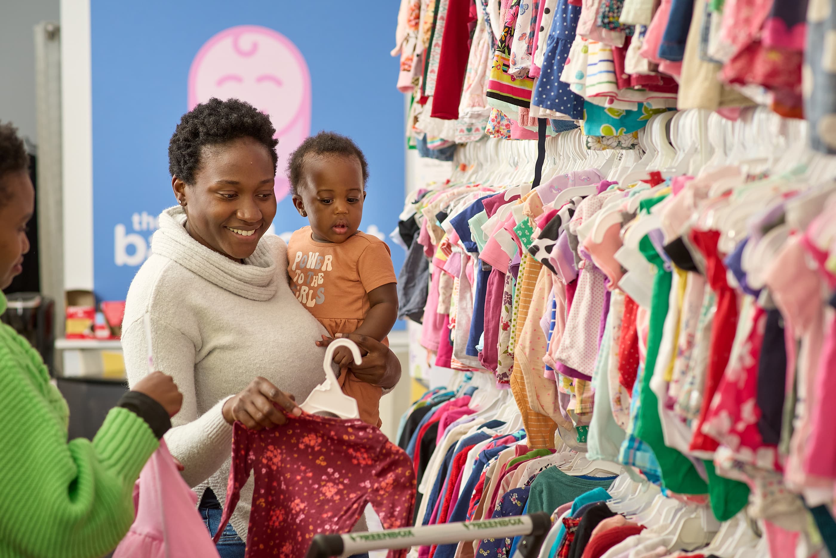 A Cradle & Kind team member arranging baby essentials.