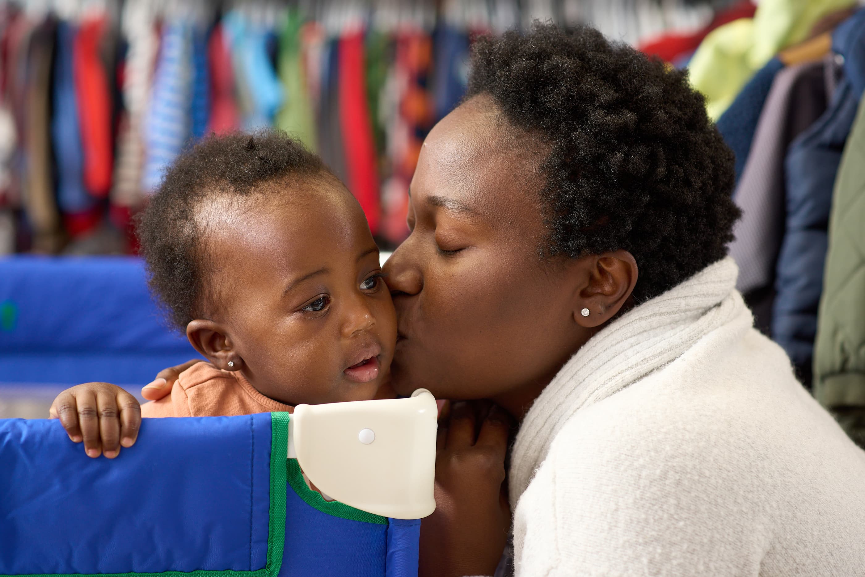 A mother kissing her baby